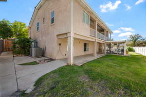 Back of property featuring a sunroom, stucco siding, a balcony, and a patio