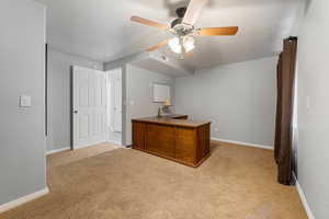 Office area featuring light carpet, a textured ceiling, and ceiling fan