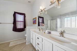 Bathroom with a textured ceiling, double vanity, a shower stall, light tile patterned flooring, and a bath