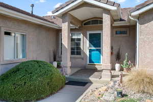 Property entrance featuring stucco siding