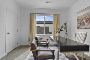 Office with light carpet and baseboards