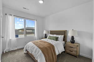 Carpeted bedroom with baseboards