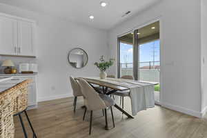 Dining space featuring light wood finished floors and recessed lighting