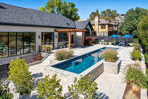 View of swimming pool with a patio area and a pergola