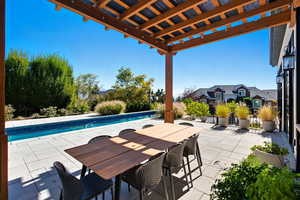 View of patio / terrace featuring a pergola, an outdoor pool, and outdoor dining space