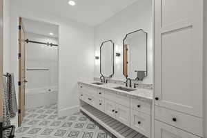 Bathroom with double vanity and recessed lighting