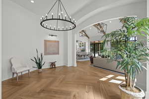 Entryway with arched walkways, recessed lighting, and high vaulted ceiling