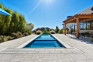 Outdoor pool featuring a patio area, a pergola, an in-ground hot tub, and outdoor dining area