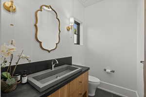 Bathroom with vanity and dark tile patterned floors