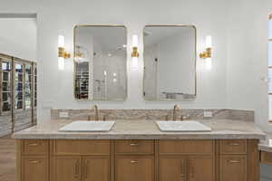 Full bathroom with tiled shower and double vanity