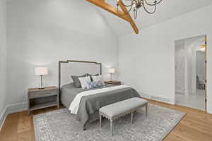 Bedroom with a chandelier, high vaulted ceiling, beamed ceiling, and light wood-type flooring