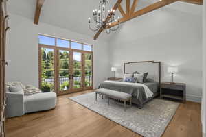 Bedroom featuring high vaulted ceiling, beam ceiling, access to exterior, light wood finished floors, and a chandelier