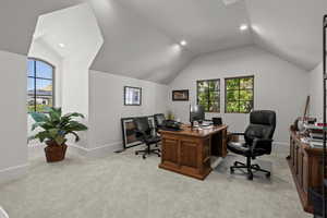 Home office featuring recessed lighting, lofted ceiling, and light colored carpet