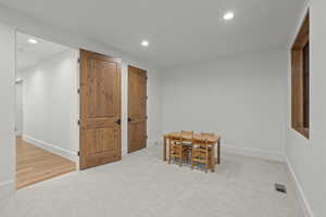 Rec room with light carpet and recessed lighting