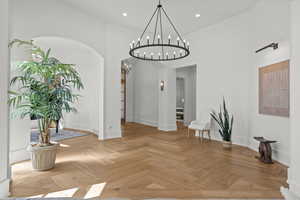 Unfurnished dining area with recessed lighting, a towering ceiling, and a chandelier