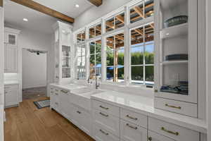 Spacious closet featuring beamed ceiling and light wood-type flooring