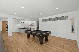 Playroom with recessed lighting, light wood-style floors, bar with sink, and pool table