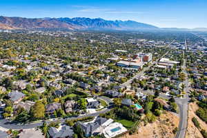 Aerial overview of property's location with mountains and nearby suburban area