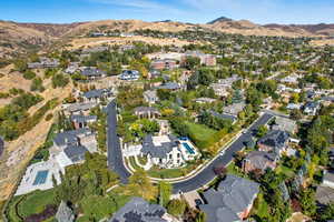 View of property location featuring mountains and nearby suburban area