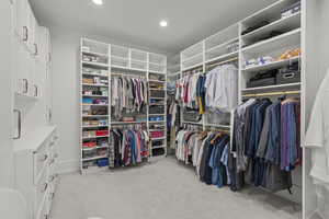 Walk in closet with light carpet