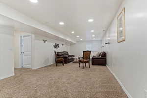 Sitting room featuring recessed lighting and light carpet