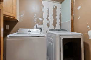 Washroom featuring washing machine and clothes dryer