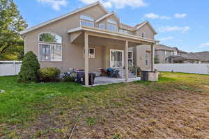 Back of property with a patio area and stucco siding
