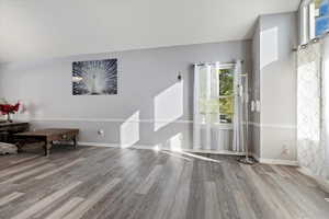 Living room featuring wood finished floors and baseboards