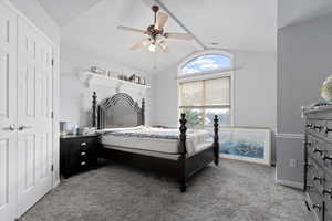 Carpeted bedroom featuring ceiling fan and baseboards
