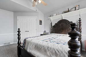 Bedroom featuring a closet, carpet, vaulted ceiling, and ceiling fan