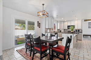 Dining area featuring recessed lighting and a chandelier