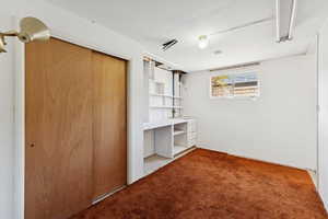 Unfurnished bedroom featuring a closet and light carpet