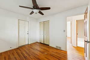 Unfurnished bedroom featuring light wood finished floors, a ceiling fan, and a closet