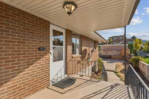 Property entrance featuring brick siding