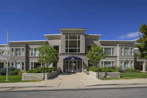 View of front facade with french doors and stucco siding