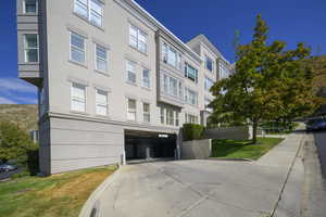 View of building exterior featuring a garage and a mountain view