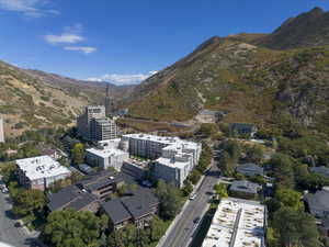 Aerial view of property and surrounding area with a mountainous background