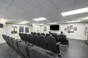 Home theater room with baseboards and a drop ceiling