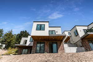 Rear view of property with brick siding