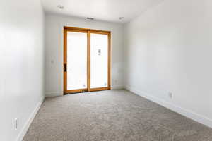 Unfurnished room with light carpet and baseboards
