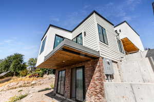 View of side of home featuring brick siding