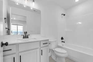 Full bath with shower / bathtub combination, recessed lighting, vanity, and light tile patterned floors