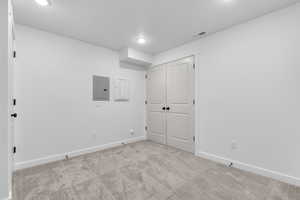 Basement featuring carpet floors and electric panel