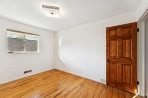 Empty room featuring wood finished floors