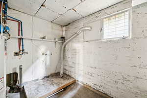 Below grade area featuring water heater