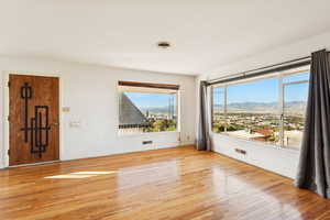 Unfurnished room with light wood finished floors and a mountain view
