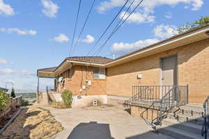 Rear view of property featuring brick siding
