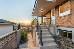 Exterior entry at dusk featuring brick siding