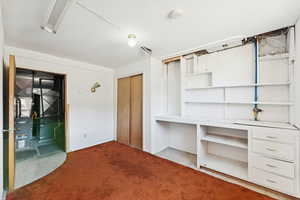 Unfurnished bedroom with a closet and light colored carpet