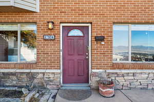 Doorway to property featuring brick siding and a mountain view